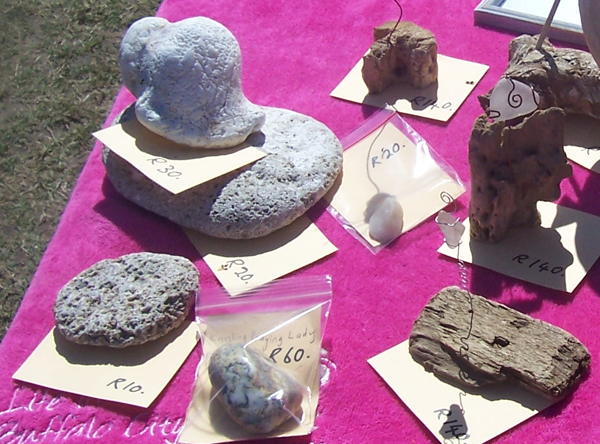 beachcombing and beach craft items on a pink beach towel